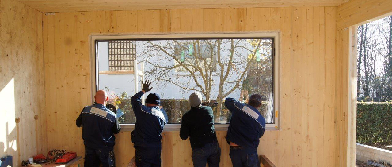 Vier Monteure von Fenster-Schmidinger tauschen eine große Glastafel aus. Fenster-Schmidinger Ihr Glasnotdienst in Linz.